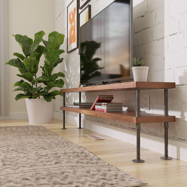 Modern living room featuring a wall-mounted TV above a two-tier wooden shelf with decorative plants and books, creating a cozy, minimalist vibe.