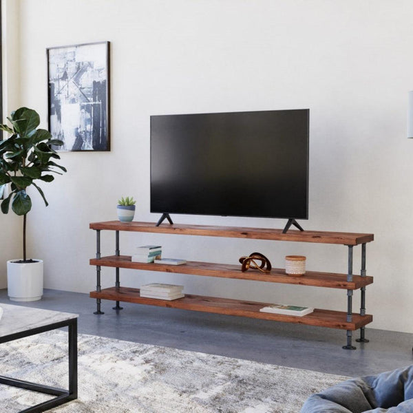 Modern living room with a sleek TV on a wooden stand, accented by tasteful decor and indoor plants, creating a welcoming space. #HomeDecor #MinimalistLiving #InteriorDesign #LivingRoomInspiration