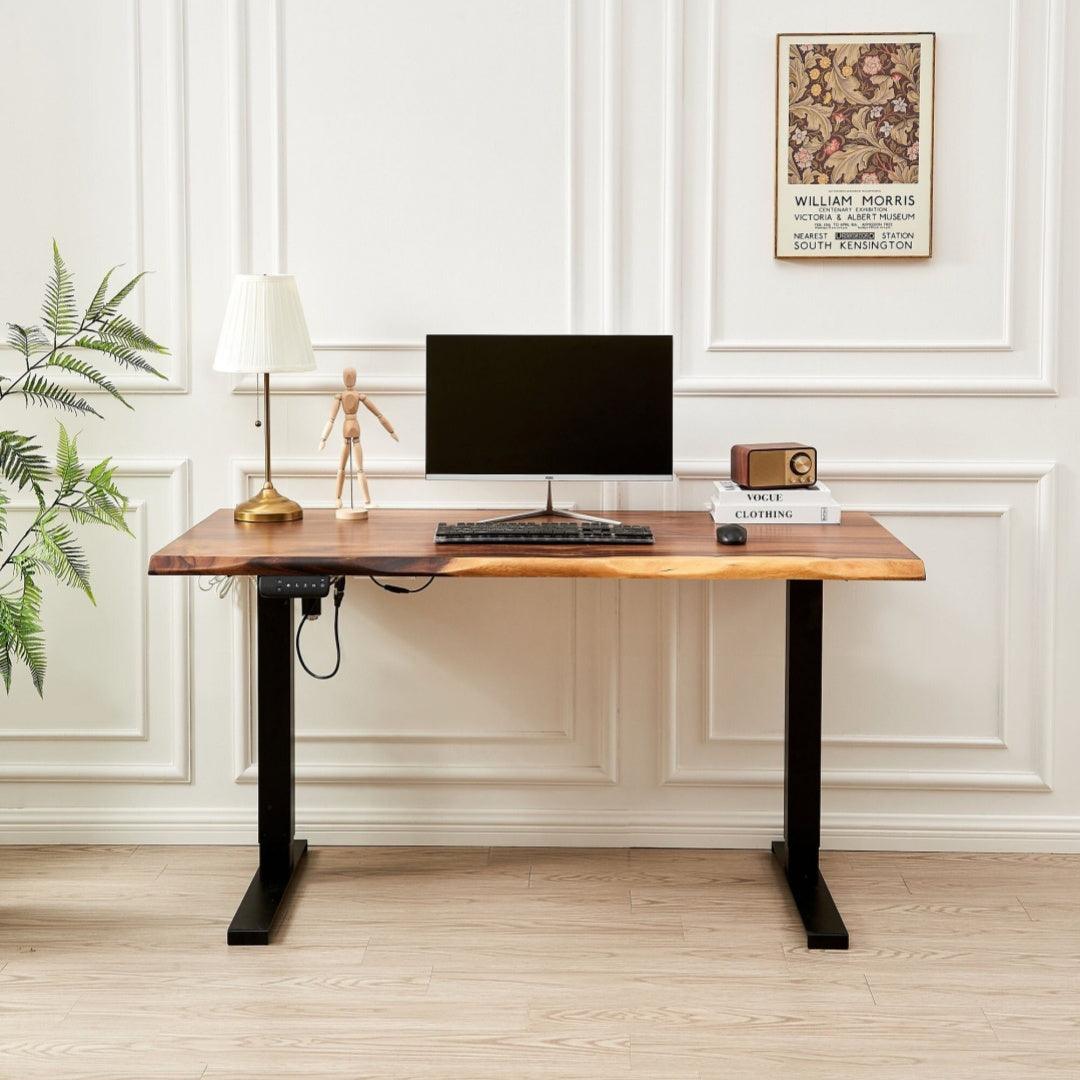 Elegant wooden desk in a bright room with white walls, featuring a modern computer, classic table lamp, and decorative items, offering a blend of traditional and contemporary workspace styles.