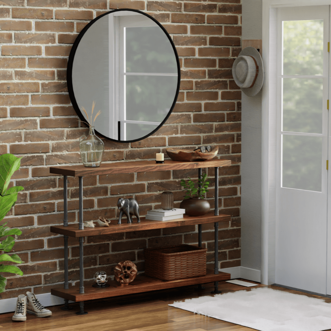 Rustic wooden shelves adorned with eclectic decor are paired with an oversized round mirror, creating a cozy and stylish corner against a warm brick wall backdrop.