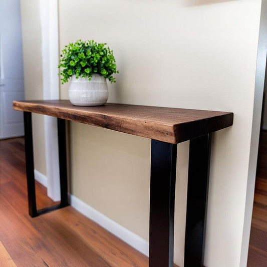 Elegant minimalist wood and metal console table with a lush green plant in a textured white vase, enhancing modern home decor. Perfect for compact spaces.