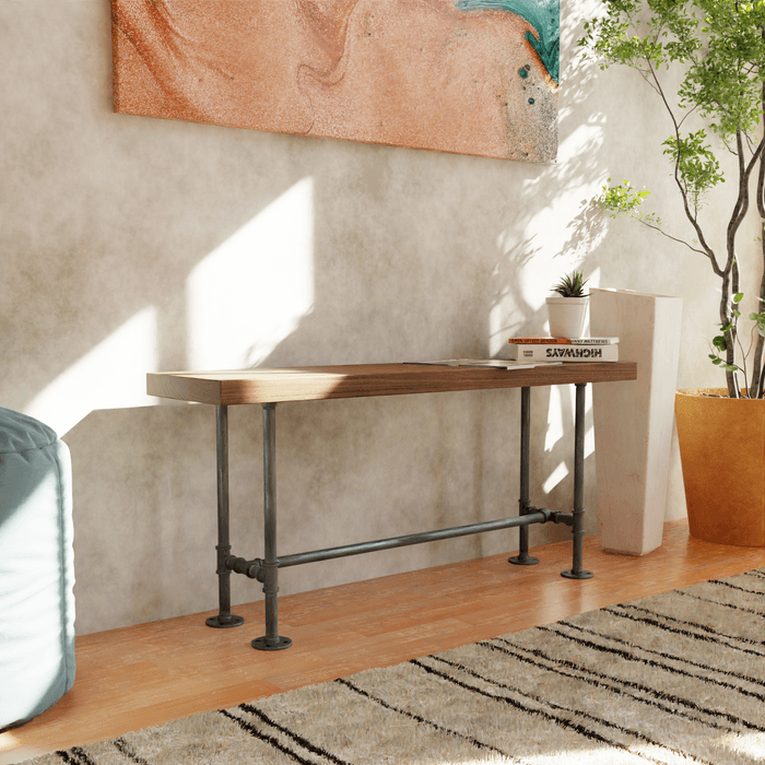 A cozy, sunlit corner featuring a modern wood and metal console table, accented by indoor greenery and a vibrant wall art piece, creating a welcoming minimalist space.