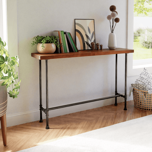 Elegant modern console table with industrial flair, featuring books, greenery, and art decor in a bright room, enhancing home interior charm. #HomeDecor #ConsoleTable #ModernLiving #InteriorDesign #MinimalistStyle